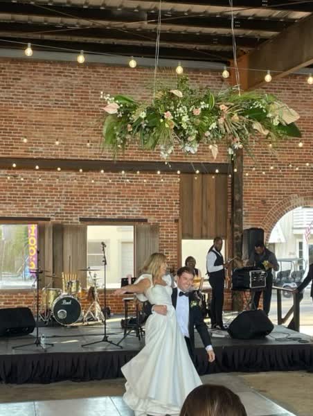 Couple two-stepping at their reception