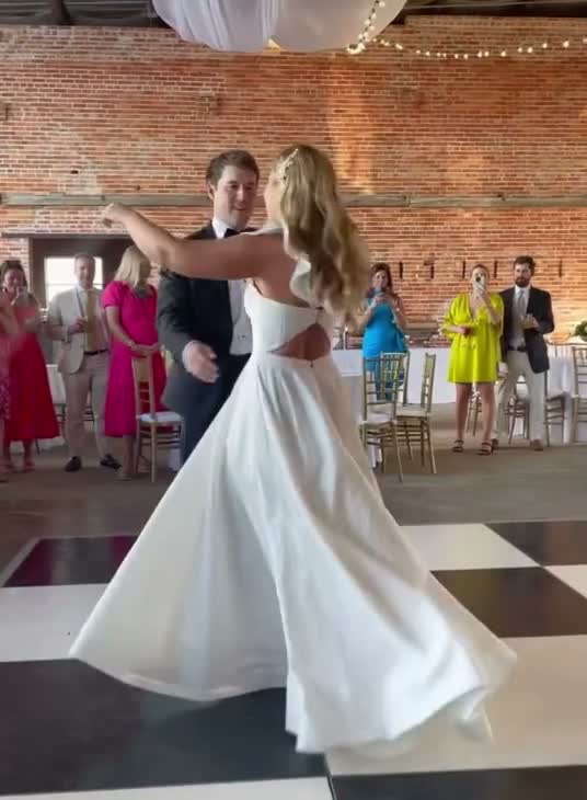 Bride mid-twirl during the first dance